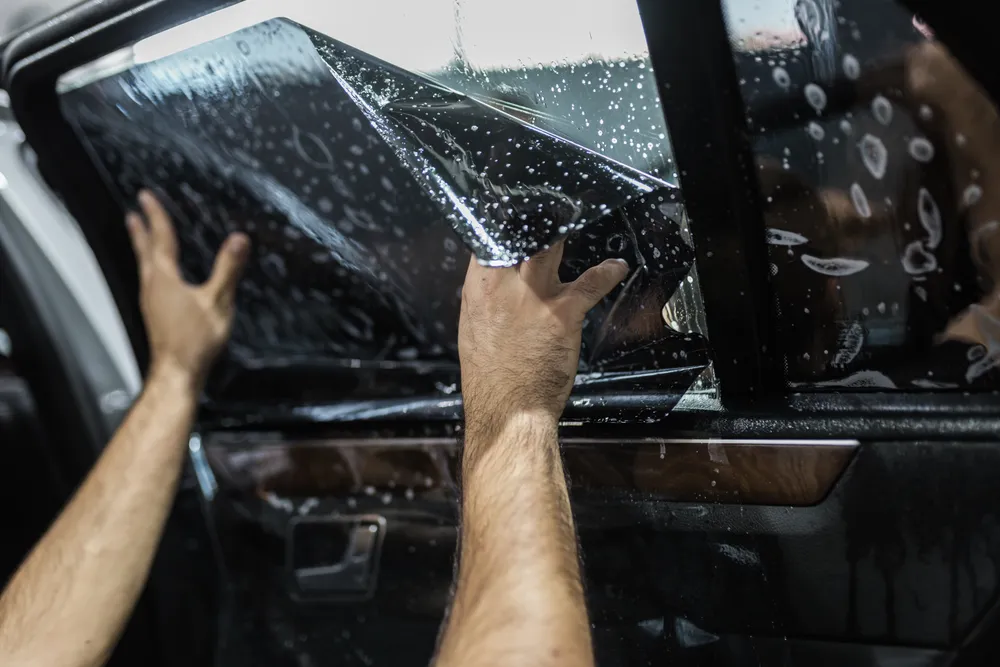 Window tint film being installed
